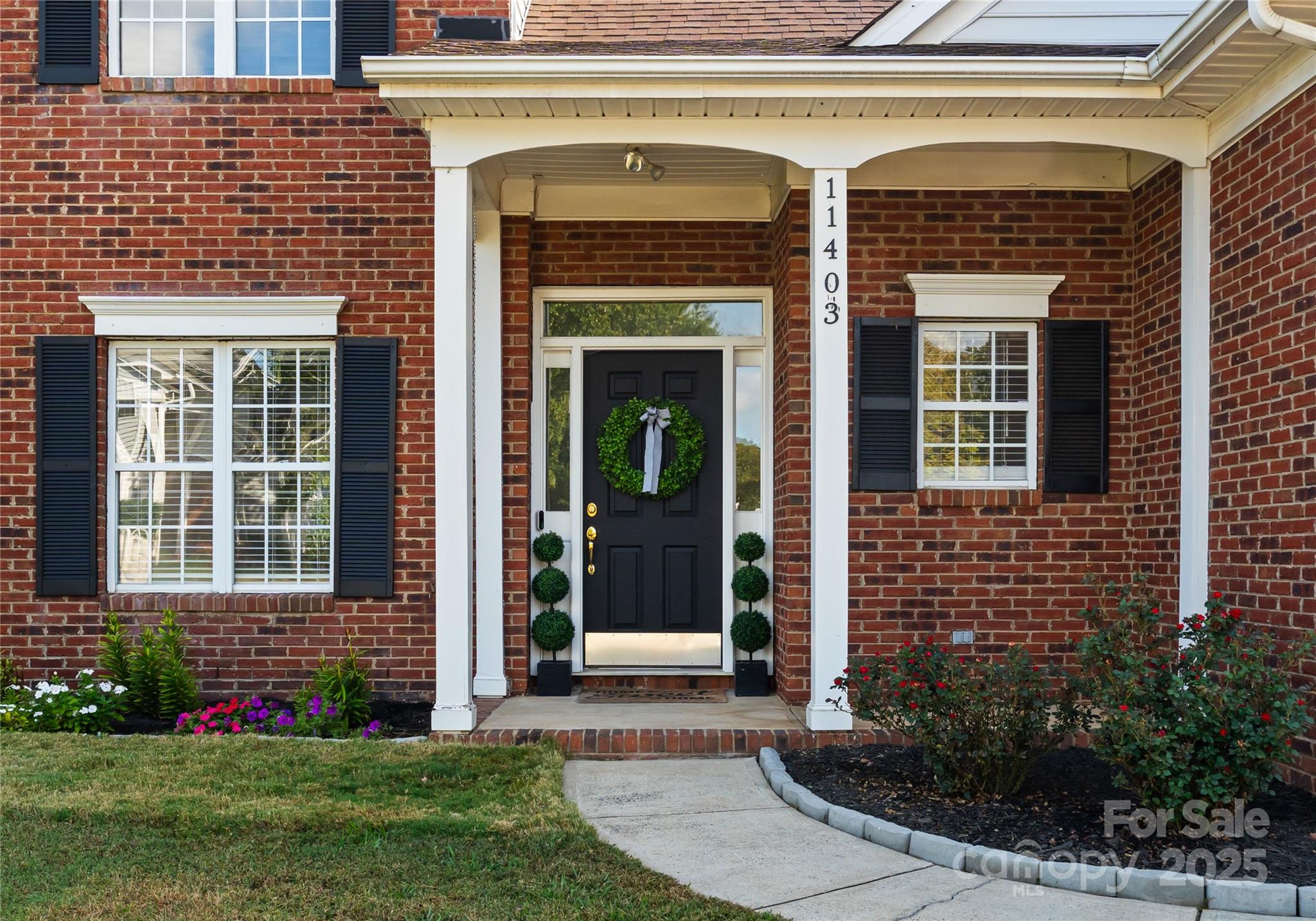 11403 Ridge Oak Drive Charlotte, NC 28273 - Photo 2 of 45 a front view of a house with garden