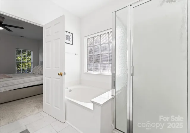 a bathroom with a bathtub and a shower