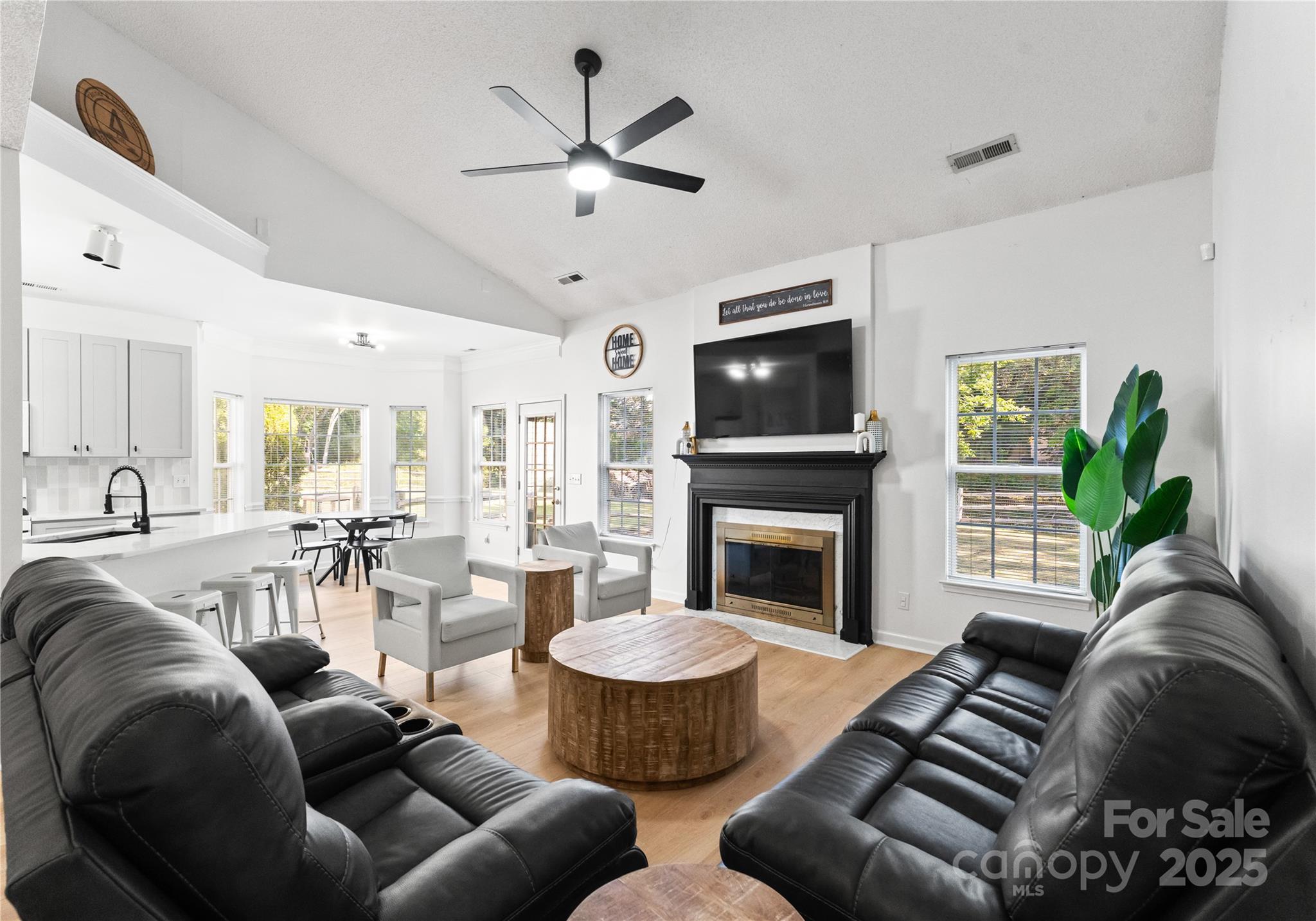 11403 Ridge Oak Drive Charlotte, NC 28273 - Photo 3 of 45 a living room with furniture a fireplace and a flat screen tv