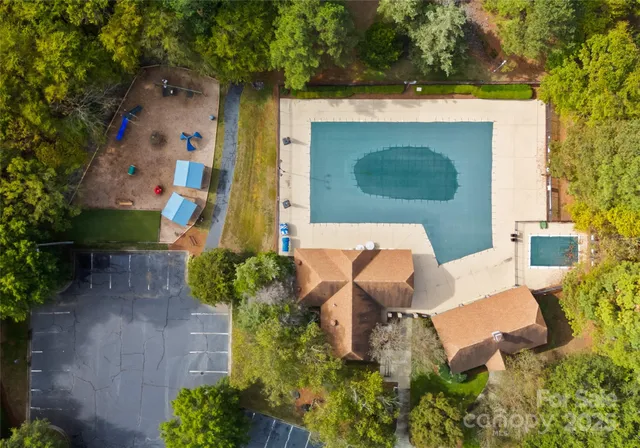 an aerial view of a house with a yard and trees