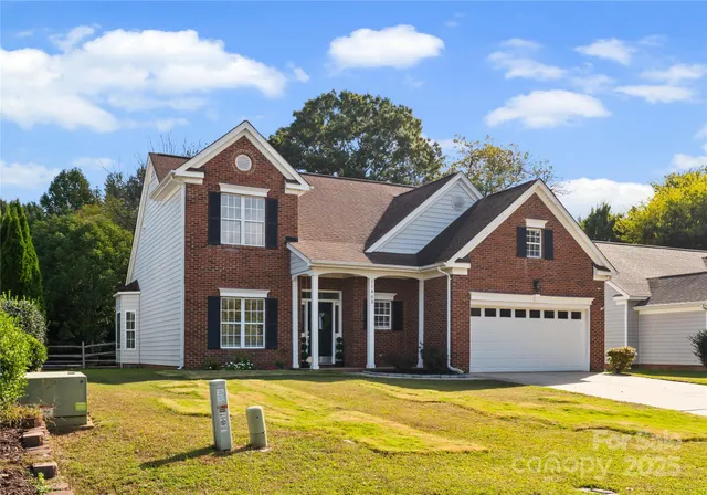 a view of a house with pool and a yard