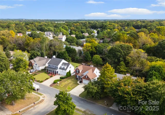 an aerial view of a houses with a lake view