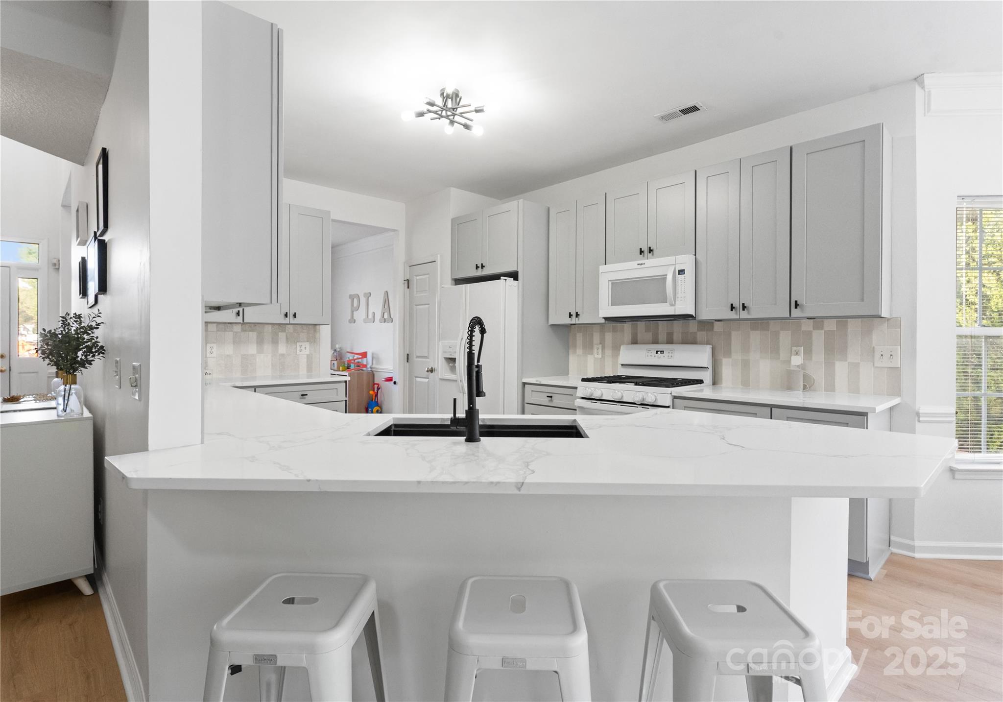 11403 Ridge Oak Drive Charlotte, NC 28273 - Photo 7 of 45 a kitchen with stainless steel appliances a sink a stove a refrigerator cabinets and a window