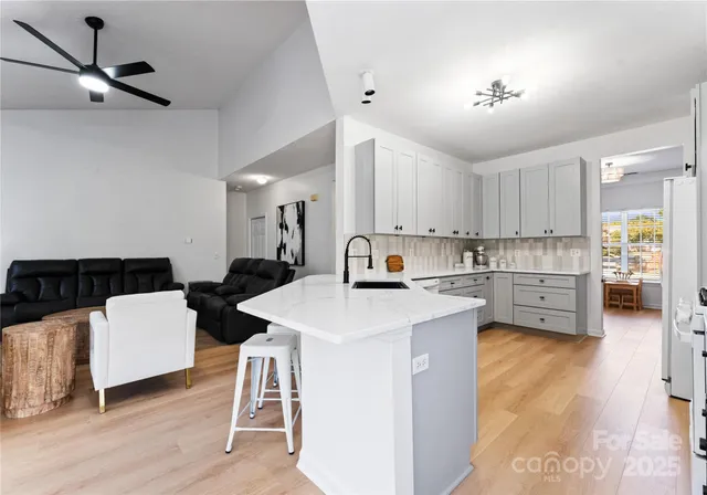 a kitchen with a sink appliances and cabinets