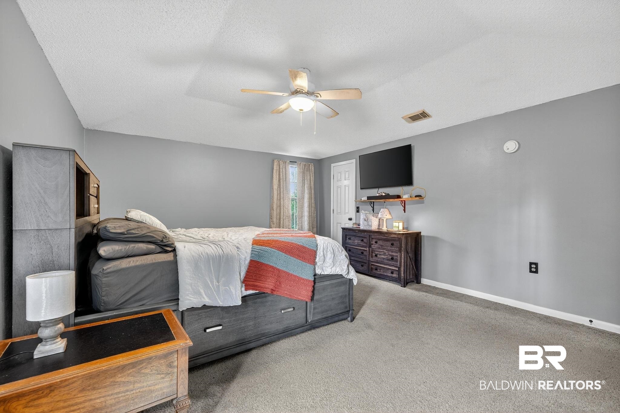 21895 2nd Street Silverhill, AL 36576 - Photo 31 of 43 Primary bedroom with carpet, a ceiling fan, and two closets
