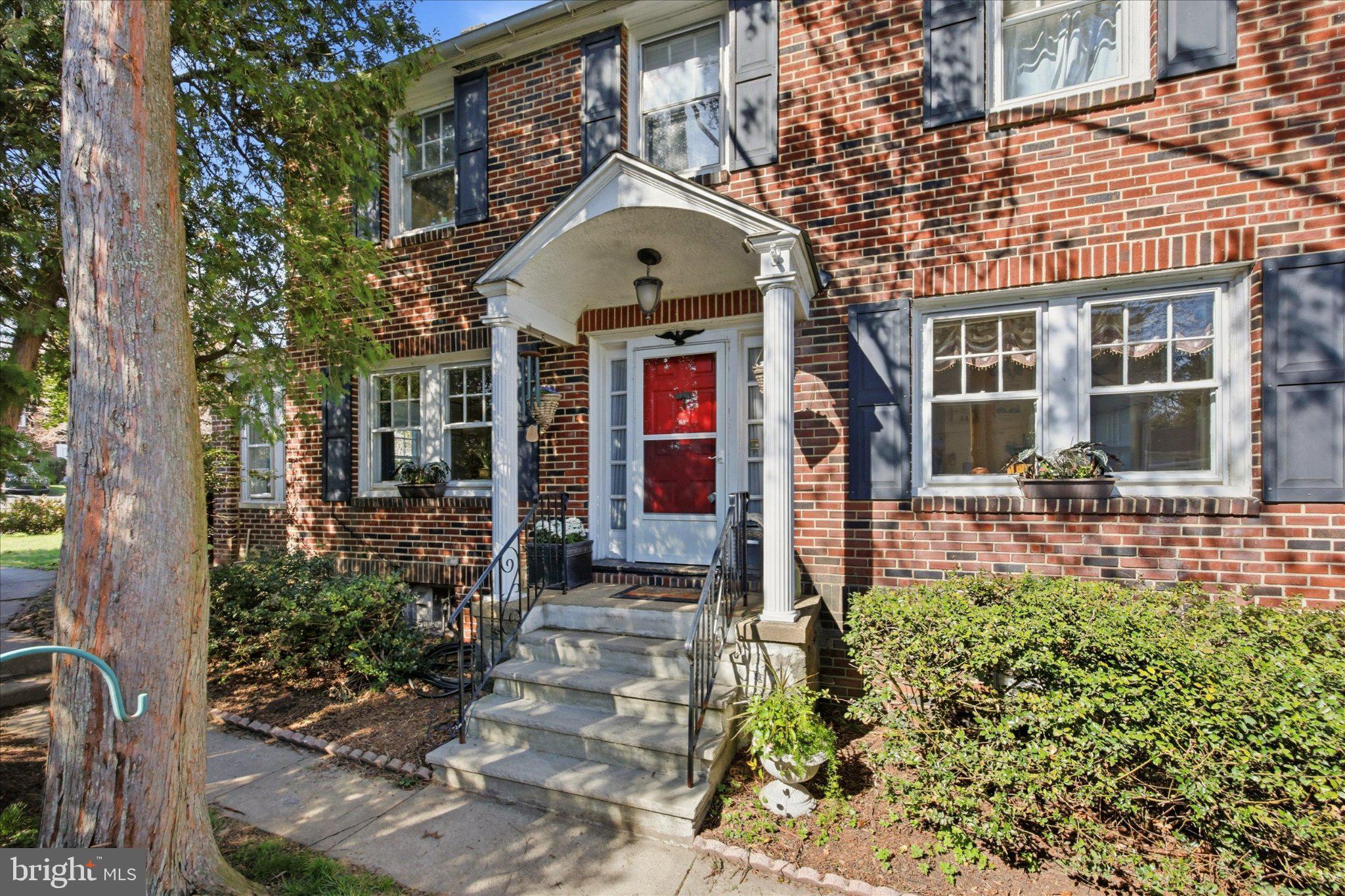 Charming brick facade with vibrant entry.