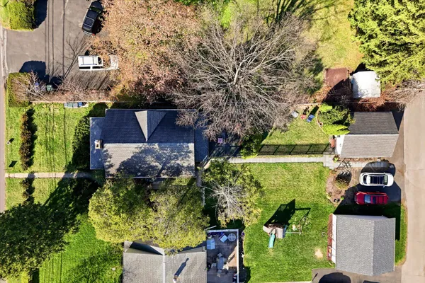 an aerial view of a house with a yard