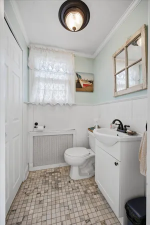 a bathroom with a sink a toilet and a mirror