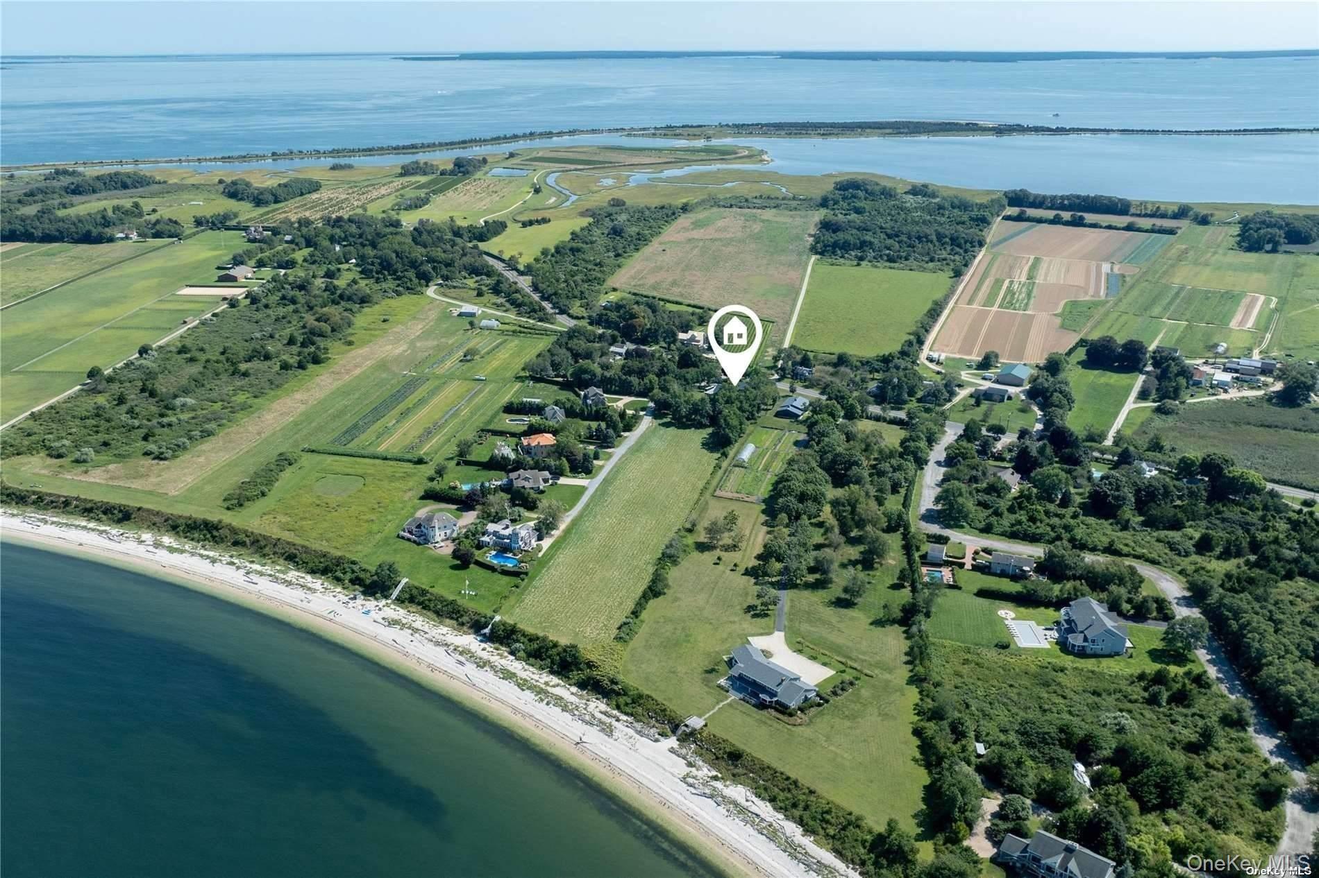 290 Windward Road Orient, NY 11957 - Photo 2 of 31 an aerial view of a golf course with a lake view