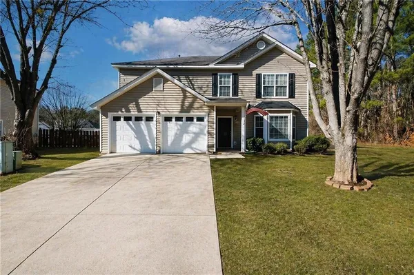 a front view of a house with a yard