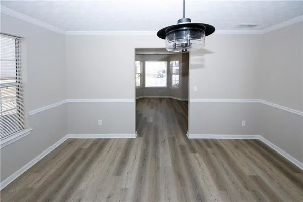 a view of wooden floor and chandelier in a room