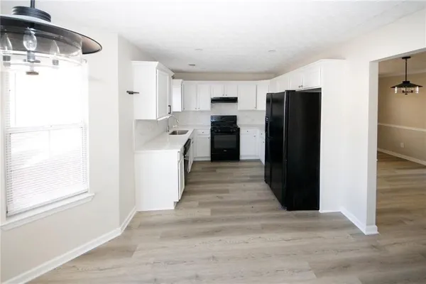 a kitchen with a refrigerator and a sink