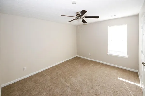 a view of a room with a ceiling fan