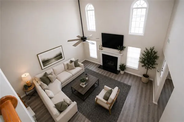 a living room with furniture a flat screen tv and a fireplace