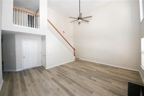 a view of a room with wooden floor and a fireplace
