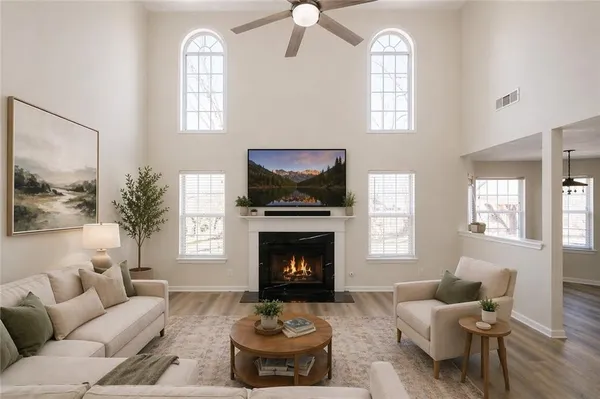 a living room with furniture fireplace and window