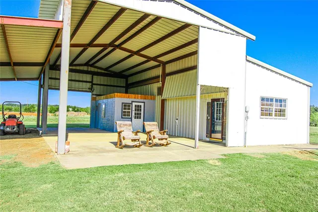 a view of a patio with a table and chairs