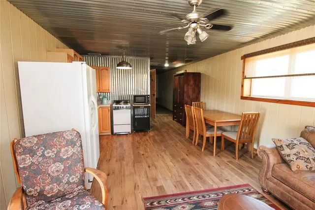 a living room with furniture and kitchen view