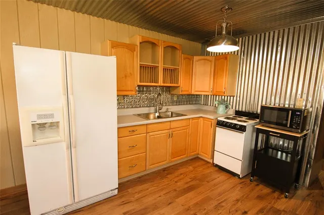 a kitchen with stainless steel appliances a refrigerator and a stove