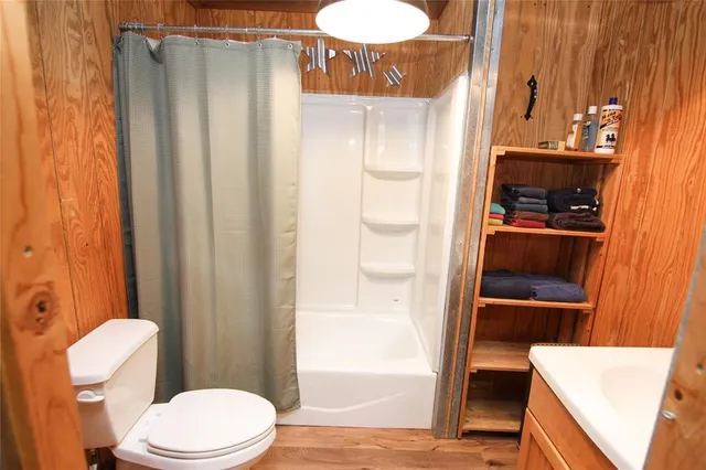 a bathroom with a toilet a sink and shower