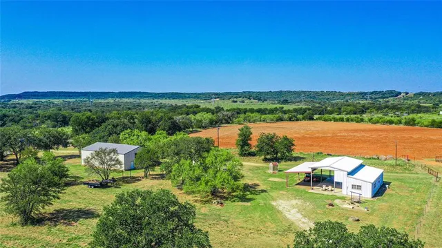 a view of a lake with couches in the back