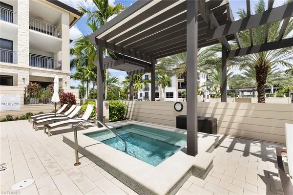 a swimming pool with outdoor seating and yard