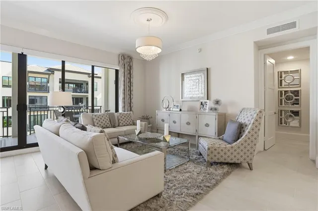 a living room with furniture and a dining table