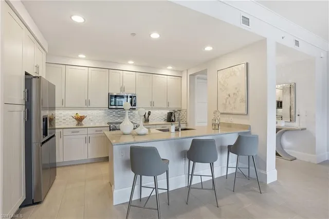 a kitchen with appliances cabinets and furniture
