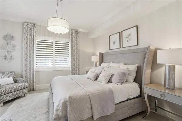 a bedroom with a bed furniture and a flat screen tv