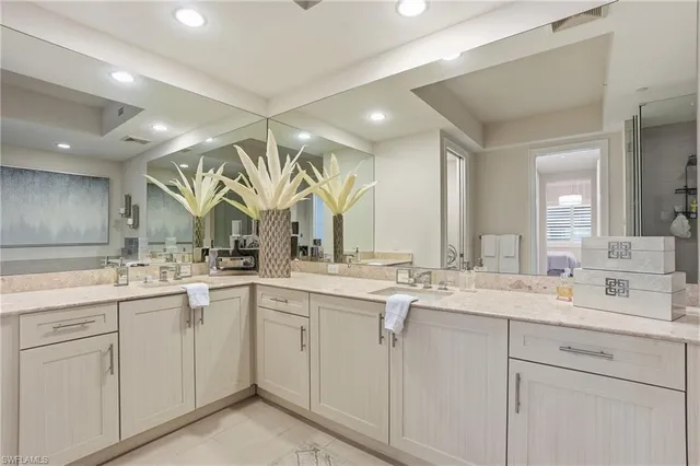 a view with double vanity sink a mirror a vanity and a window