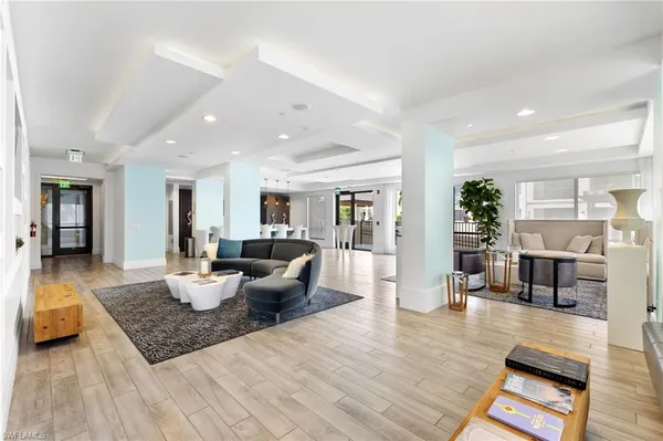 a room with lots of wooden furniture wooden floor and windows
