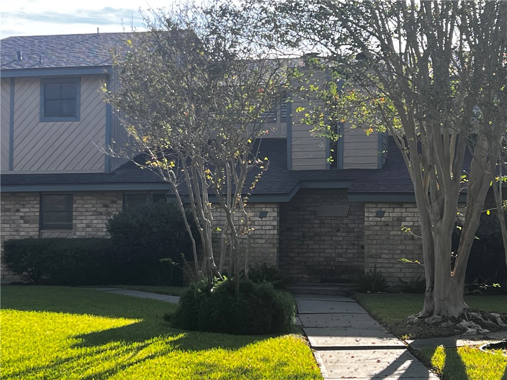 5180 Middlecoff Circle, Unit B Corpus Christi, TX 78413 - Photo 2 of 11 a view of a yard with a tree