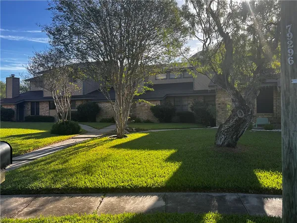 a view of a house with swimming pool and a yard