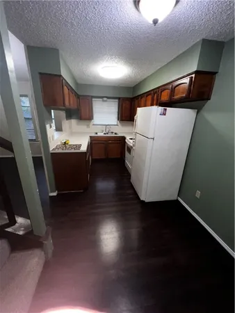 a view of kitchen and utility room with wooden floor