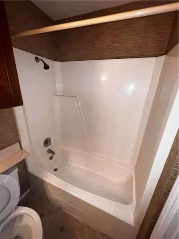 a bathroom with a bathtub and toilet
