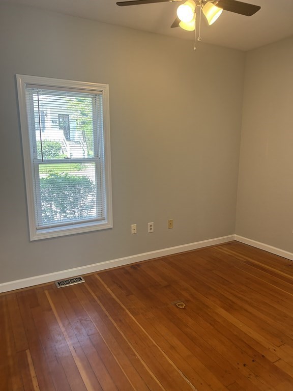 46 Tatman Street Worcester, MA 01607 - Photo 11 of 31 a view of an empty room with wooden floor and a window
