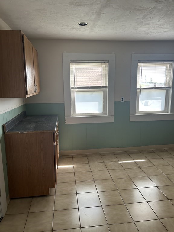 46 Tatman Street Worcester, MA 01607 - Photo 18 of 31 an empty room with windows and fan