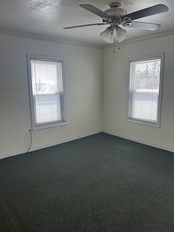 46 Tatman Street Worcester, MA 01607 - Photo 24 of 31 an empty room with a window and a fan