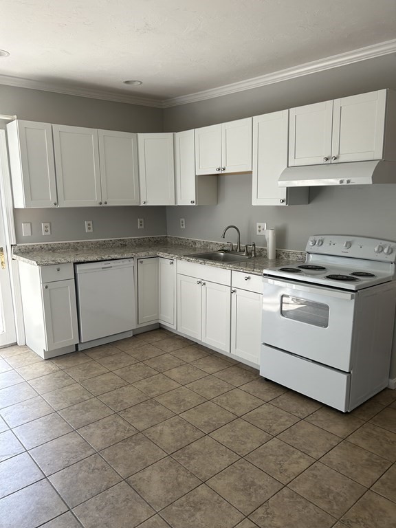 46 Tatman Street Worcester, MA 01607 - Photo 5 of 31 a kitchen with a sink and cabinets