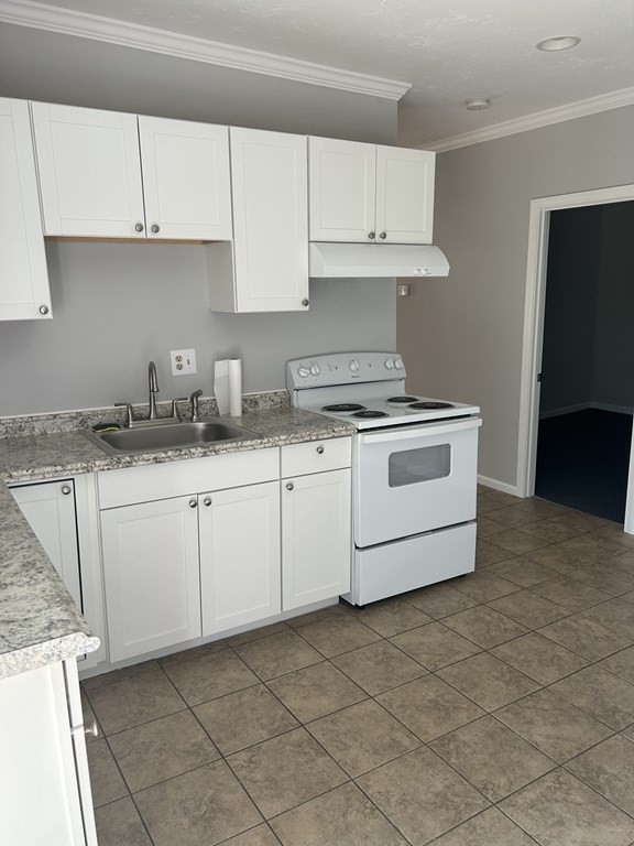 46 Tatman Street Worcester, MA 01607 - Photo 6 of 31 a kitchen with granite countertop white cabinets and white appliances