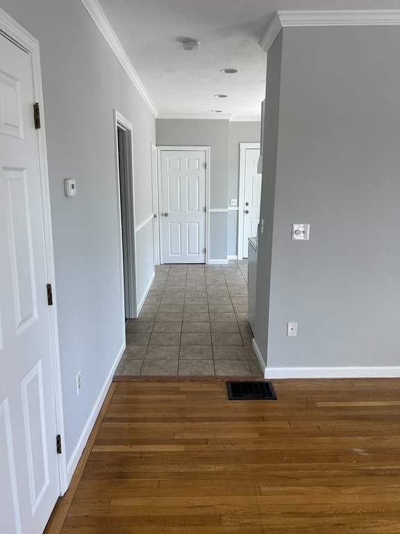 46 Tatman Street Worcester, MA 01607 - Photo 7 of 31 a view of a hallway with wooden floor and staircase