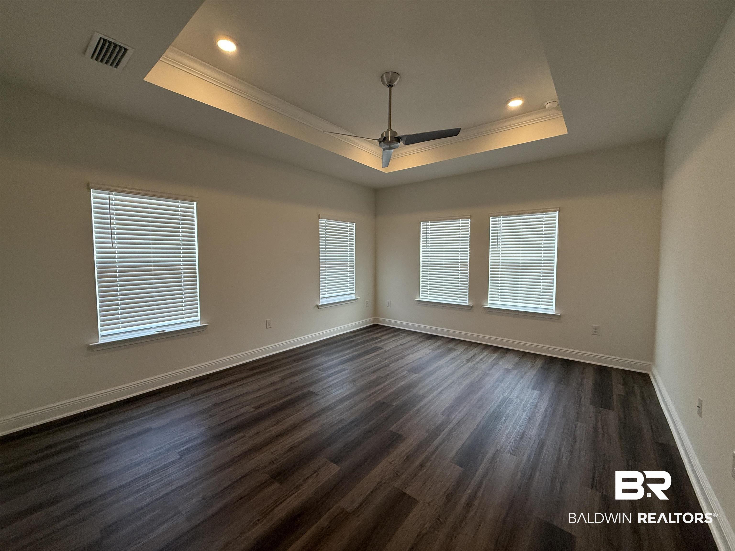 11442 Genuine Risk Circle Daphne, AL 36526 - Photo 9 of 21 Empty room with a ceiling fan, crown molding, dark wood finished floors, and recessed lighting