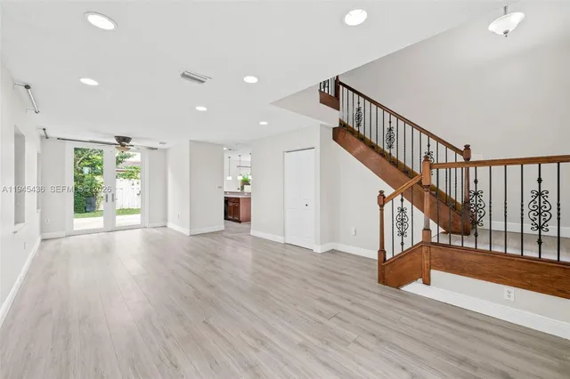a view of entryway and hall with wooden floor