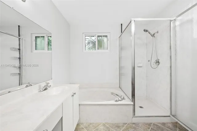 a bathroom with a granite countertop sink mirror and shower