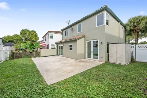 a view of a house with a yard and garage