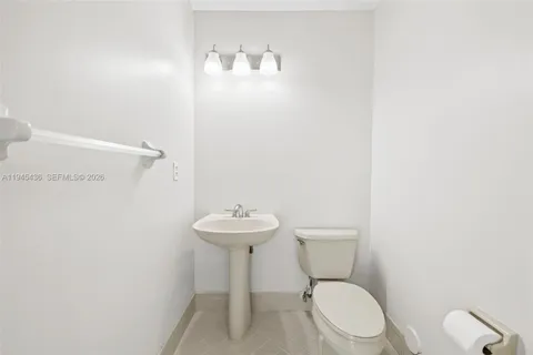 a white toilet sitting next to a white sink