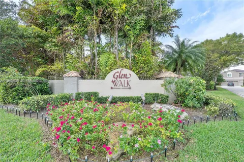 a view of a sign in front of flowers