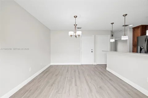 a view of a room with wooden floor and windows