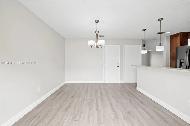 a view of a room with wooden floor and windows