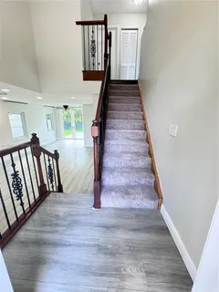 a view of entryway and hall with wooden floor